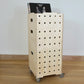 A set of three modern birch plywood stacking square crates sitting on a wooden floor. The crates have 4 castors & the front has 5 vertical rows of drilled holes, the top crate has records stacked inside