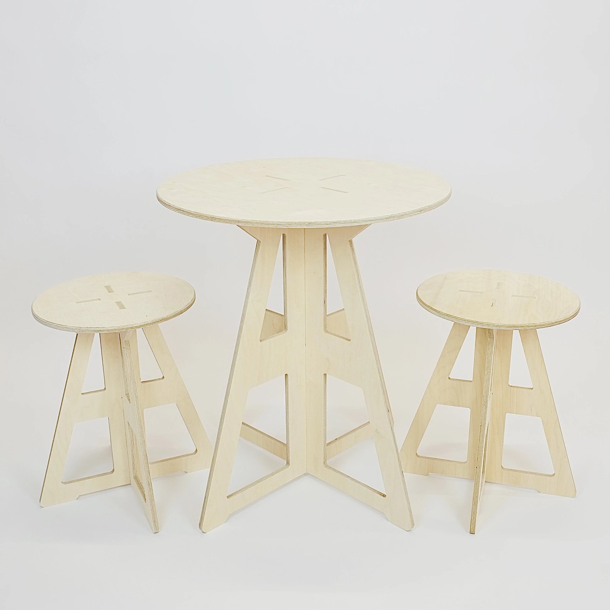 A simple modern pale wooden small table top and legs. It has a round top and triangle legs which have slotted together in a cross shape with  two matching stools.