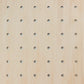 A close up of a pale wooden pegboard showing the round peg holes and the wood grain.