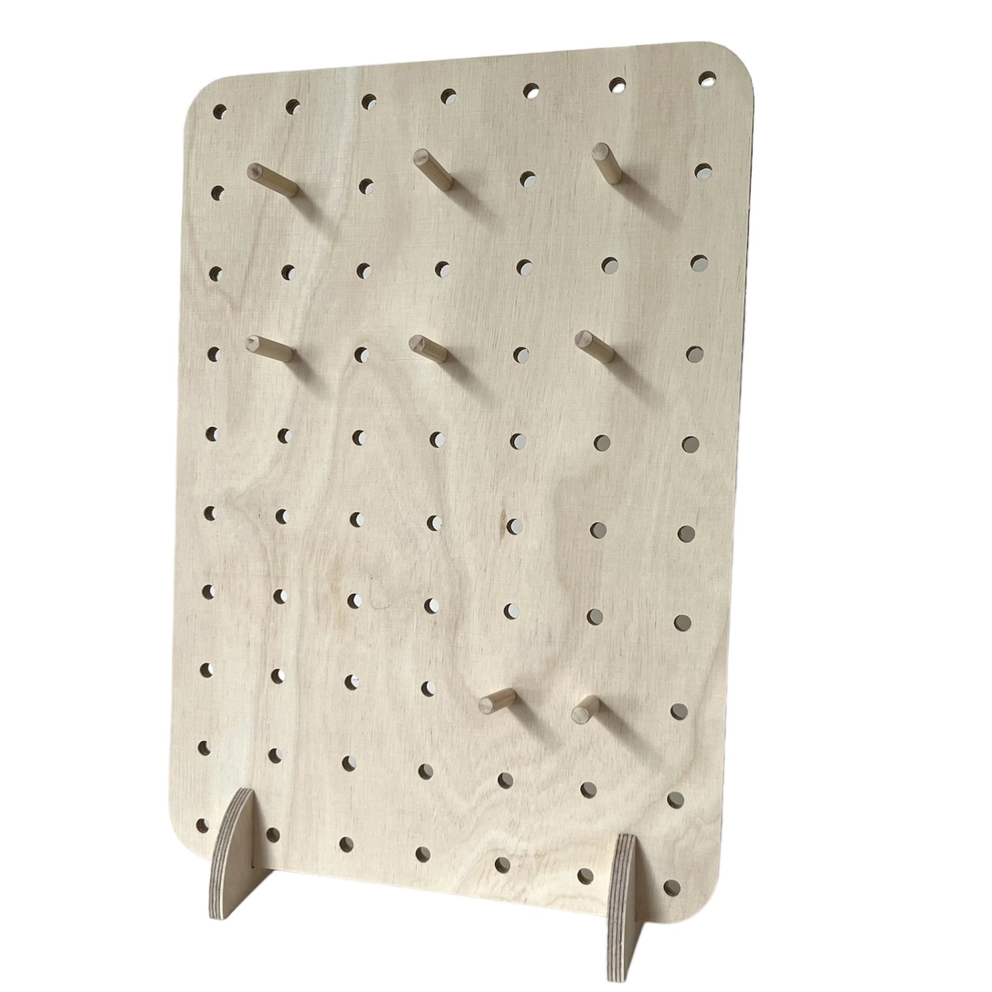 Pale wooden pegboard with small 6mm drilled holes and eight pegs facing to left