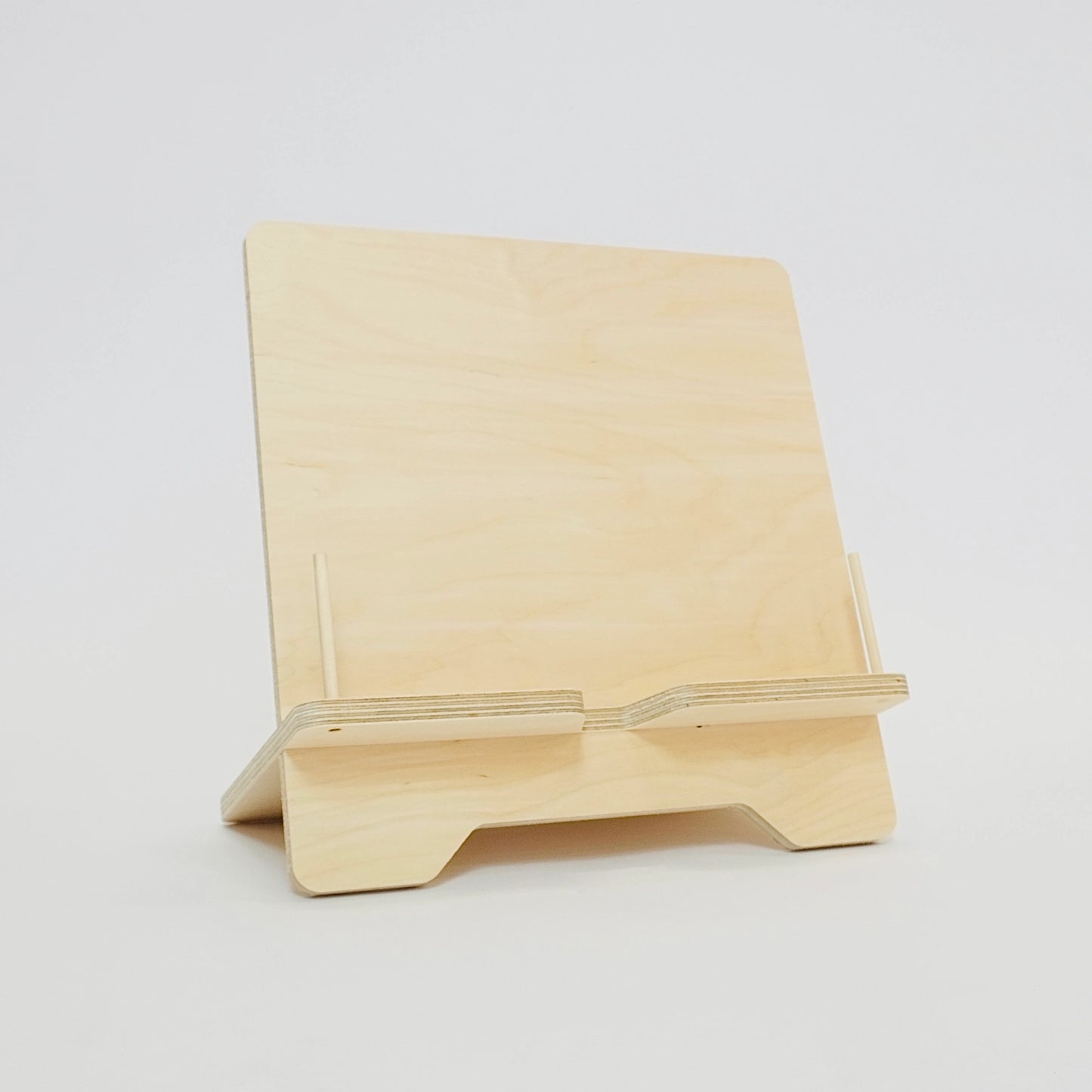 Front facing wooden plywood book stand with pegs to hold pages open