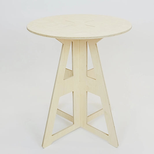 A simple modern pale wooden small table. It has a round top and triangle legs which have slotted together in a cross shape, the base is wider than the top. The top also features four grooves where the legs have slotted into the top.