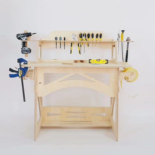 A pale wooden work bench sits facing the front. Tools are stored on the work bench. 