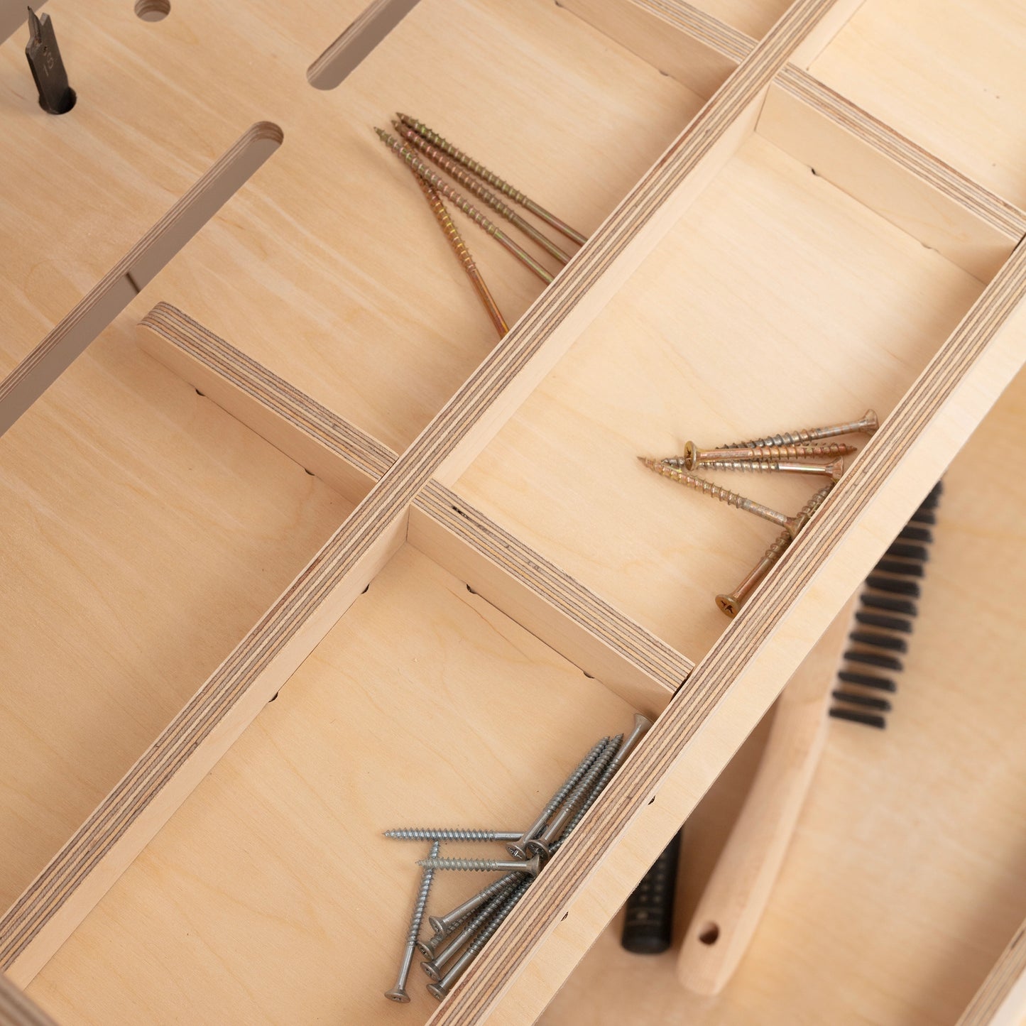 detail of tool storage holding screws on tool trolley made from birch plywood