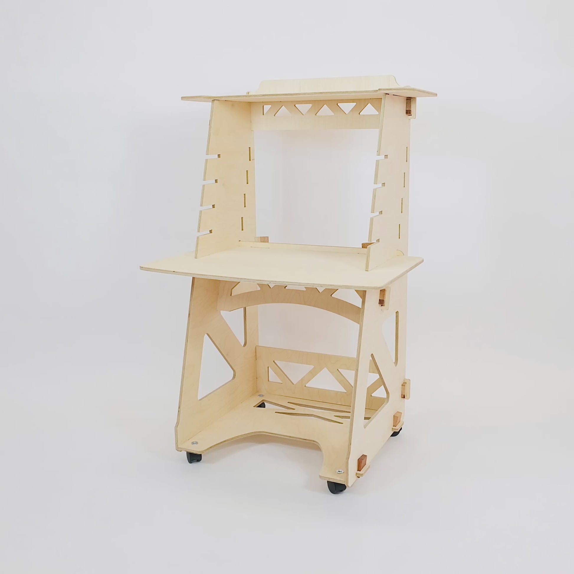Animation of the different desk heights of a birch plywood stand up/sit down desk against a white wall